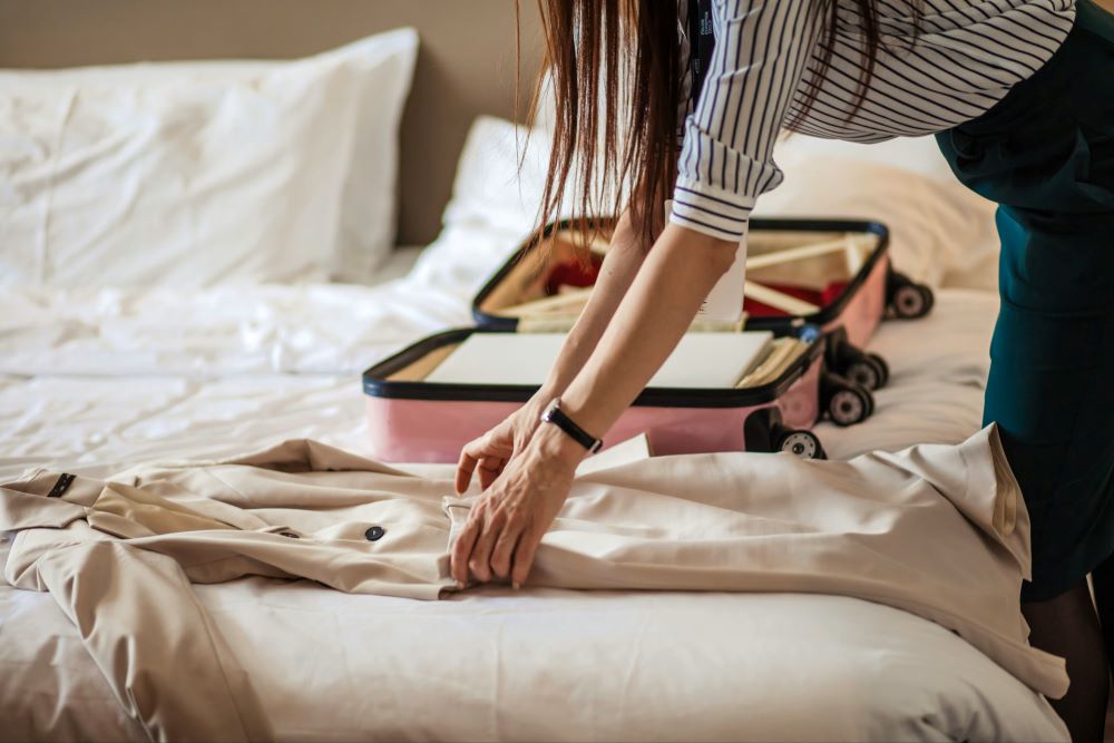 A woman packing her bags to attend treatment away from home