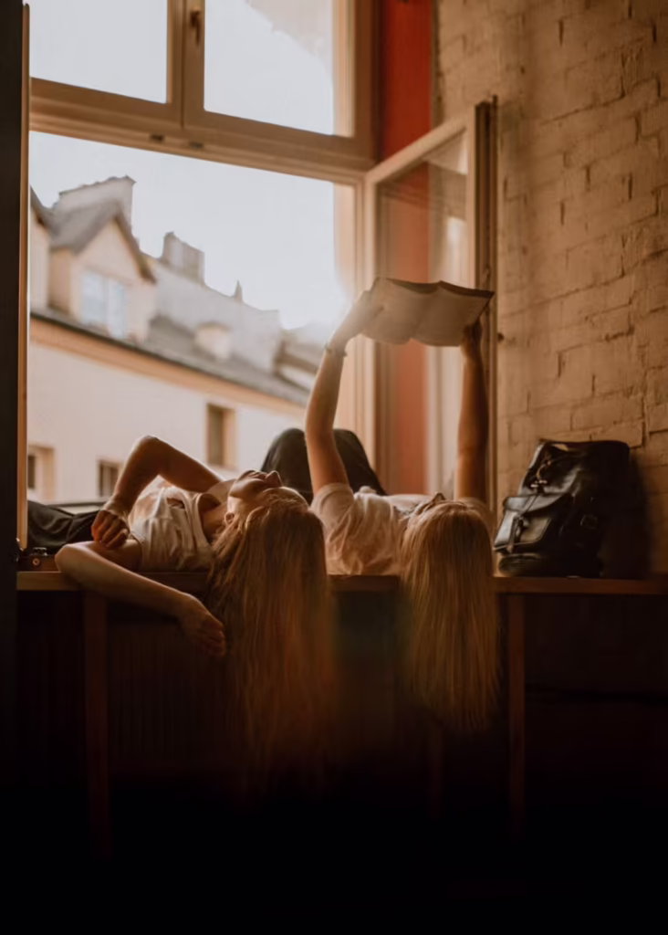 Two women lying down and reading in cannabis rehab