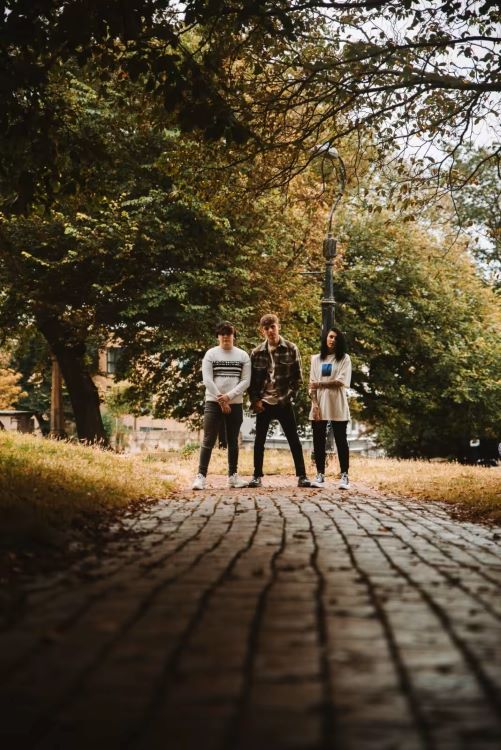 Three people standing outside of a synthetic drug rehab center
